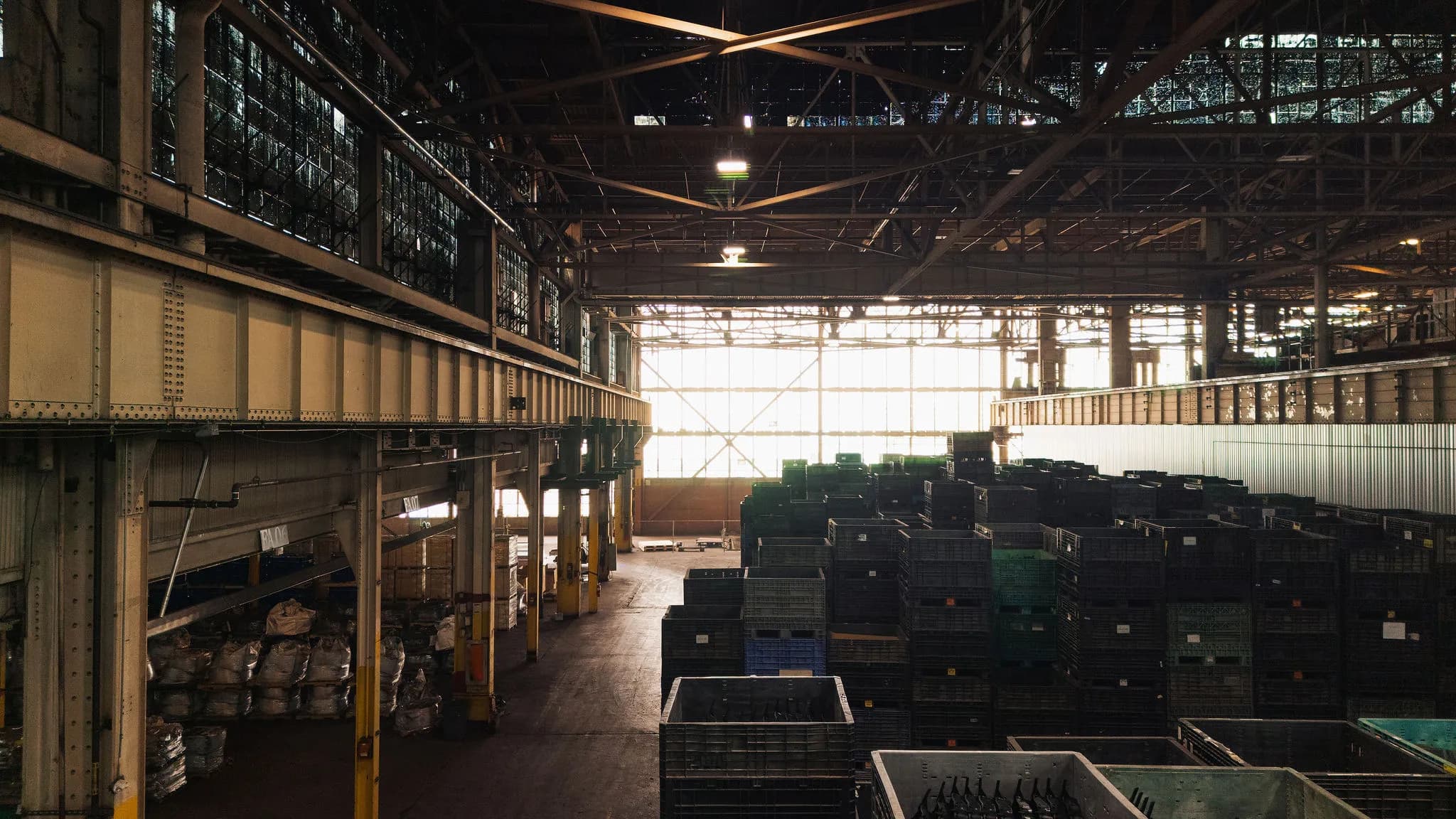 Large warehouse interior with overhead crane rails at an industrial facility