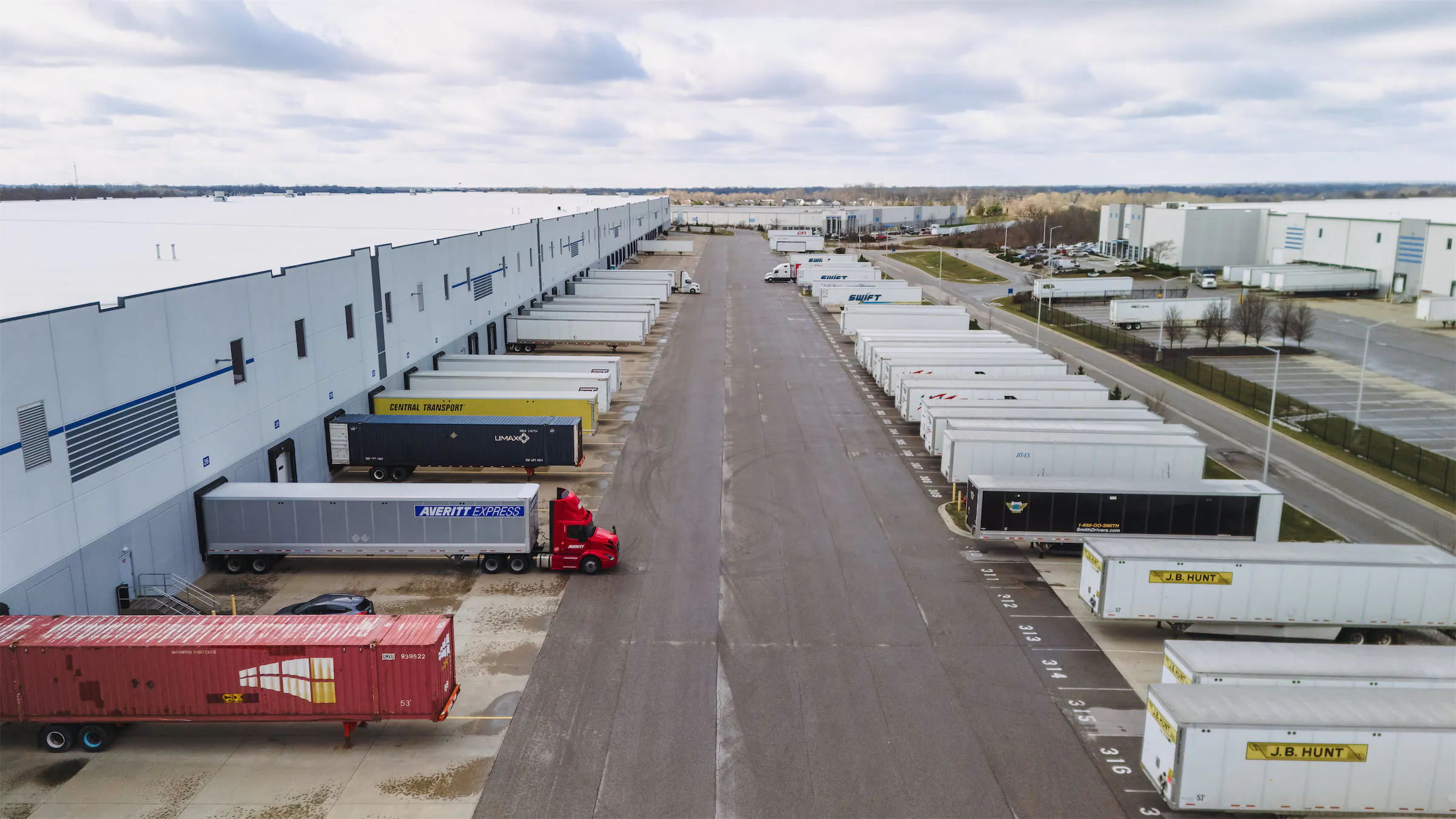 Fleet of semi-trucks at loading docks
