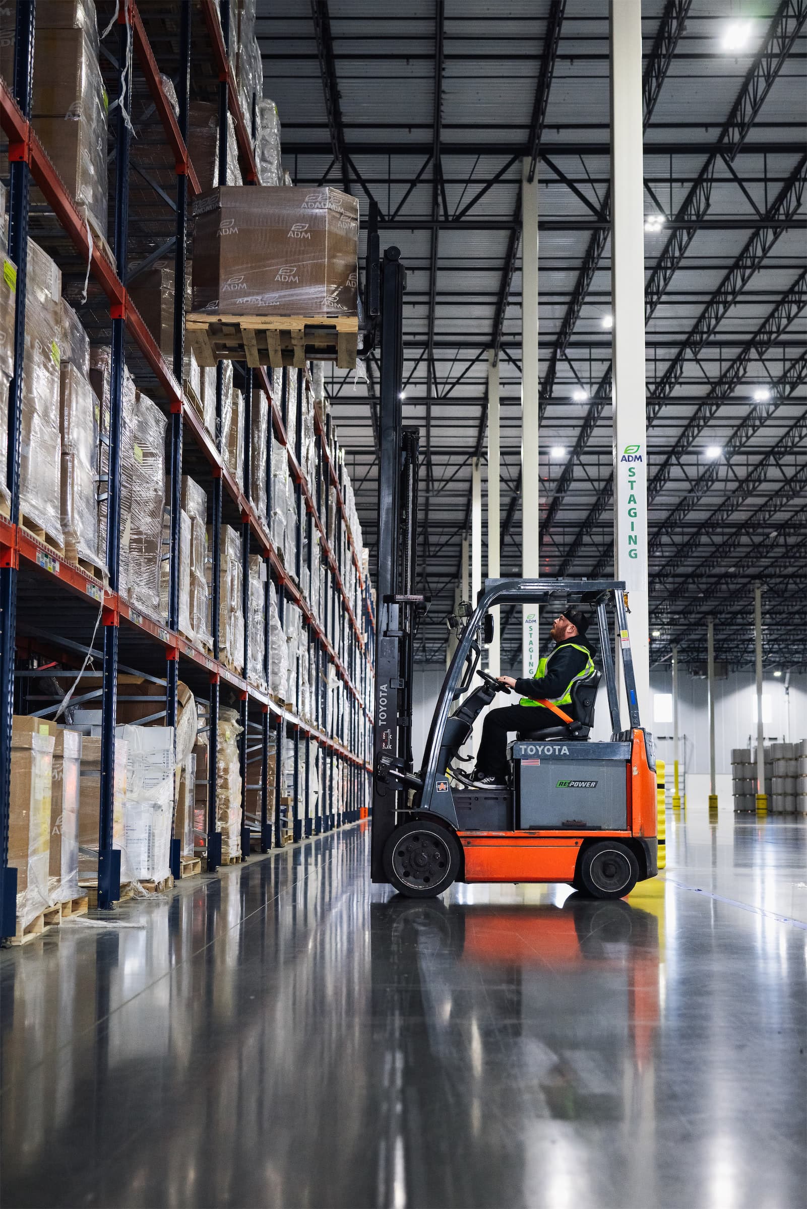Forklift operator pulling pallet from stack