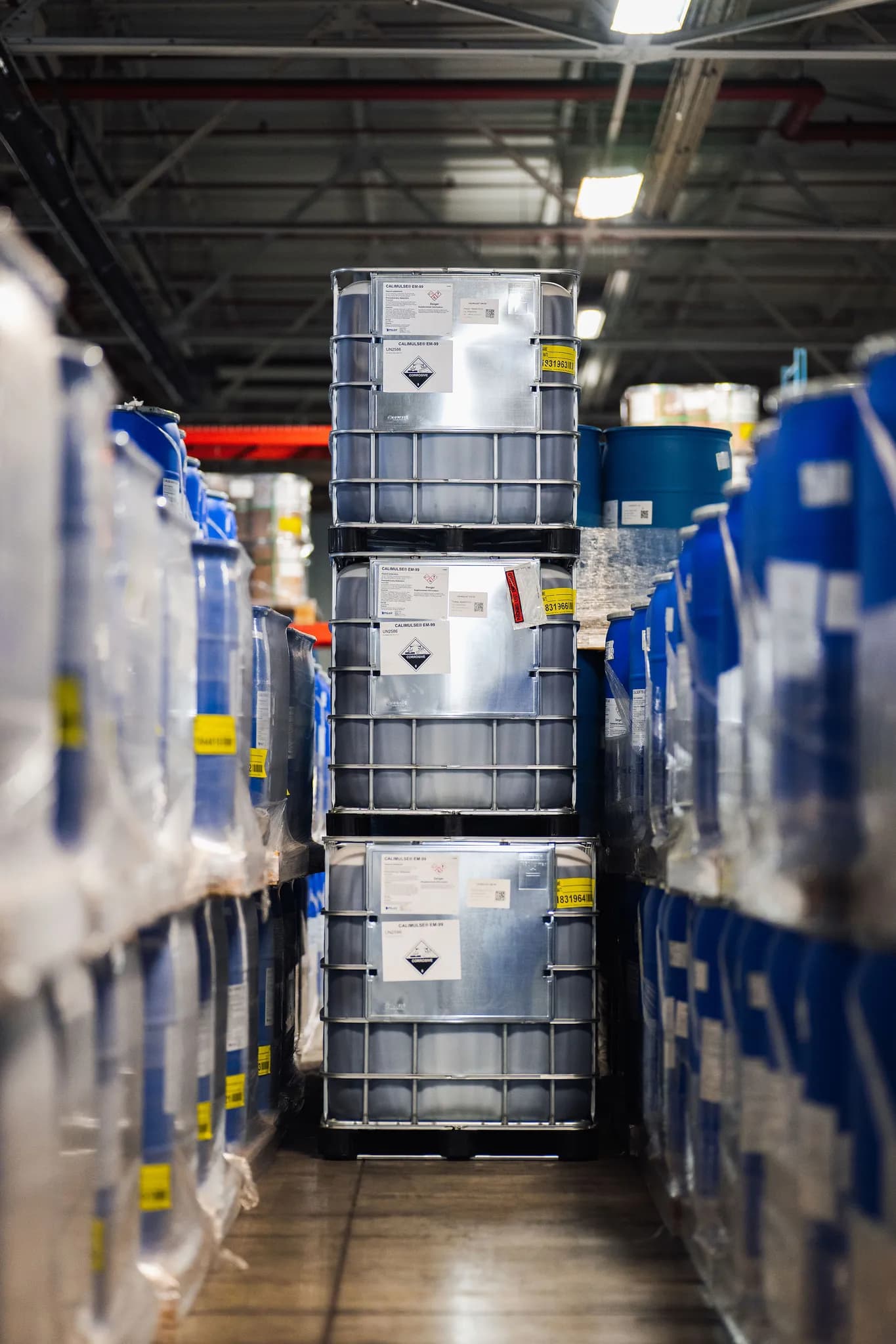 Blue chemical drums loaded on forklift at Commonwealth warehouse
