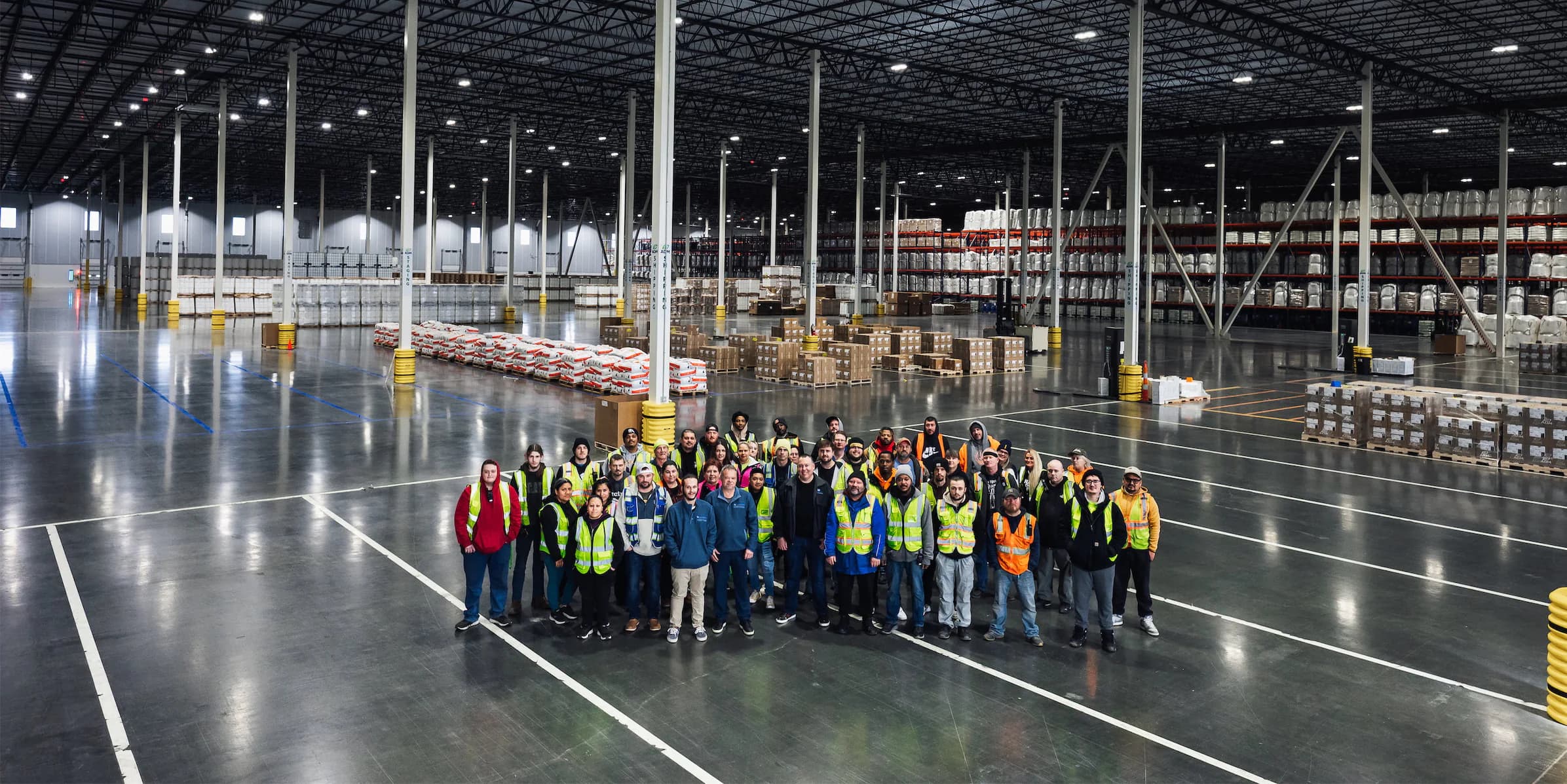 Commonwealth team standing in a warehouse facility