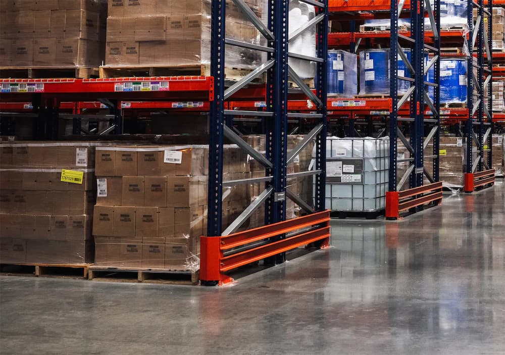 Two lift operators on warehouse floor